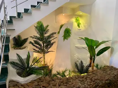 a room with a bunch of plants and stairs at Happiness Villa Majawish, close to the city center in Hurghada