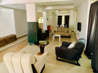 a living room with couches and chairs and a table at Happiness Villa Majawish, close to the city center in Hurghada