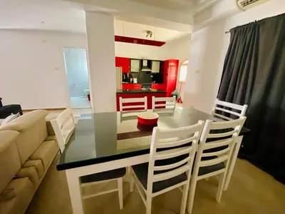 a dining room with a glass table and chairs at Happiness Villa Majawish, close to the city center in Hurghada