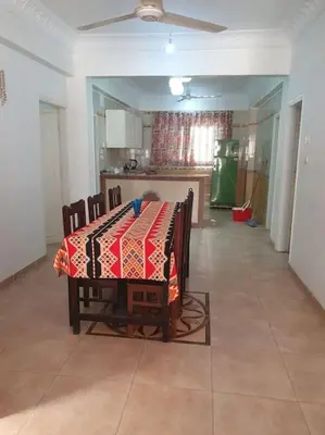 a table with a table cloth on it in a kitchen at Sekhmet Appartement 3 chambres in Luxor