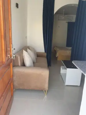 a living room with a couch and a table at Villa Omar El Sharif Appartement studio n2 in Luxor