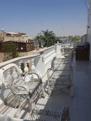 a group of chairs sitting on top of a balcony at Villa Omar El Sharif Appartement studio n2 in Luxor