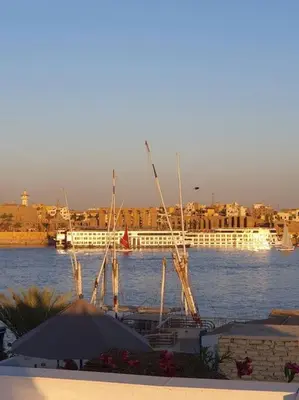 a view of a river with a boat in the water at Villa Omar El Sharif Appartement studio n2 in Luxor