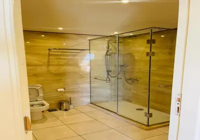 a bathroom with a glass shower with a toilet at Warm Studio MB1 at Marina El Gouna in Hurghada