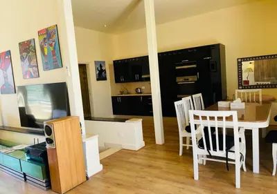 a living room with a table and a dining room at Warm Studio MB1 at Marina El Gouna in Hurghada