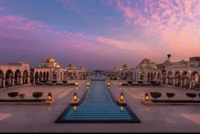 a view of a building with a fountain in the middle at Palm Beach Piazza Beachfront lovely Apartment in Hurghada