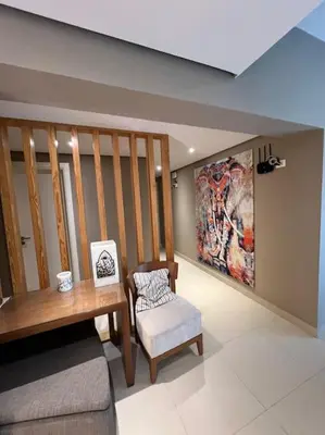 a living room with a wooden table and a chair at Modern Apartment Abutig Marina in Hurghada