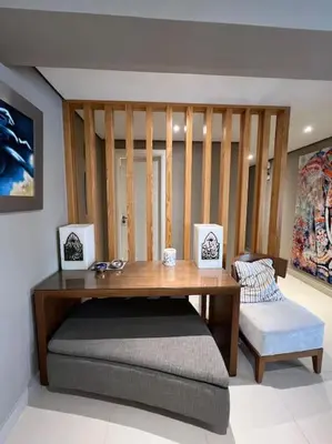 a room with a wooden table and a bench at Modern Apartment Abutig Marina in Hurghada