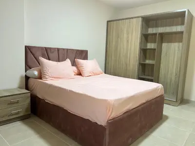 a large bed with pink pillows in a bedroom at Tiba gollden resort in Hurghada
