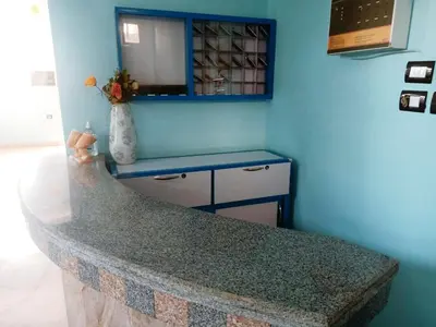 a blue room with a counter and a blue wall at Amenophis Hotel in Luxor