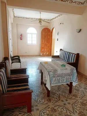 a living room with a table and two chairs at Amenophis Hotel in Luxor