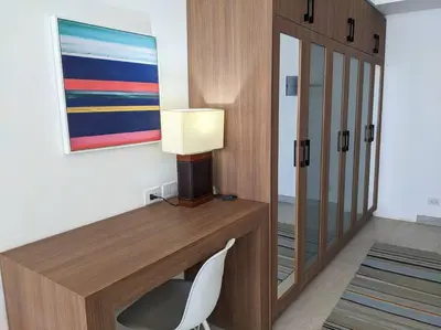 a desk with a lamp and a chair in a room at Sea View Studio in Soma Bay With Free Beach & Pool in Hurghada