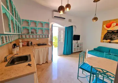 a kitchen and living room with a sink and a couch at Lovely1 Bedroom Downtown ELGouna F04 in Hurghada