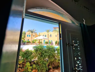 a door with a view of a resort at Lovely1 Bedroom Downtown ELGouna F04 in Hurghada