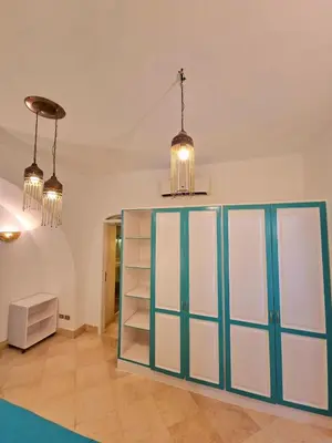 a room with a blue and white cabinet and lights at Lovely1 Bedroom Downtown ELGouna F04 in Hurghada