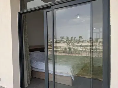 a bedroom with sliding glass doors with a bed in it at 2BR Somabay Twin Villa in Mesca Near Beach & Pools in Hurghada