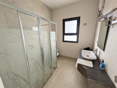 a bathroom with a shower and a toilet and a sink at 2BR Somabay Twin Villa in Mesca Near Beach & Pools in Hurghada