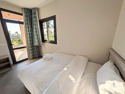 a white bed in a room with a window at 2BR Somabay Twin Villa in Mesca Near Beach & Pools in Hurghada