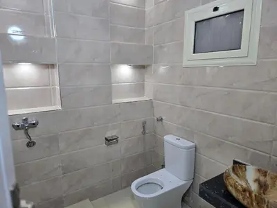 a bathroom with a toilet and a sink at siriuspalaceluxor in Al Karnak