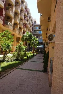 an empty sidewalk in front of a large building at Casablanca Beach - Panoramic Sea view Apartment in Hurghada