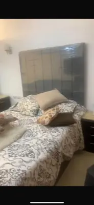 an unmade bed in a bedroom with at Diamond resort compound in Hurghada