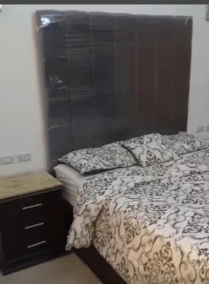 a bedroom with a bed and a dresser and a window at Diamond resort compound in Hurghada