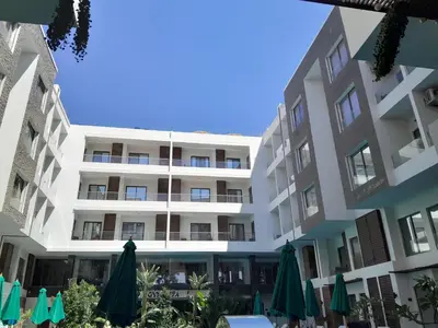 an apartment building with umbrellas and umbrellas at Cozy Studio in Hurghada bali theme resort in Hurghada