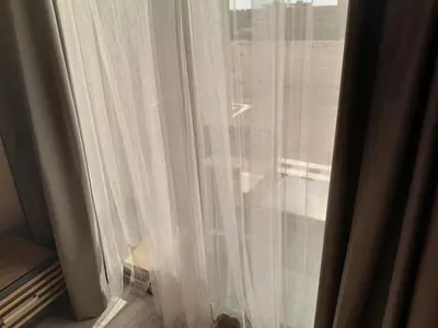 a window with white curtains on a window sill at Cozy Studio in Hurghada bali theme resort in Hurghada