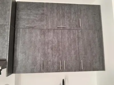 a pair of gray cabinets hanging on a wall at Cozy Studio in Hurghada bali theme resort in Hurghada