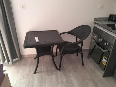 a small table and two chairs next to a kitchen at Cozy Studio in Hurghada bali theme resort in Hurghada