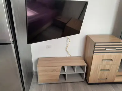 a living room with a tv and a wooden table at Cozy Studio in Hurghada bali theme resort in Hurghada