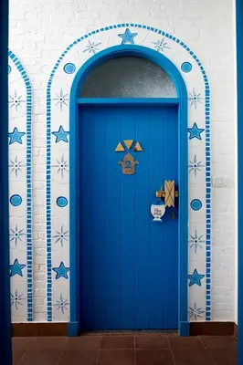 a blue door in a wall with a blue at Dolty Kato Nubian House By Kato Dool in Aswan