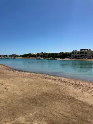 a view of a beach with buildings in the background at 2 Bedroom Ground Floor New Nubia - 2 minutes walk to marina Abu Tig in Hurghada