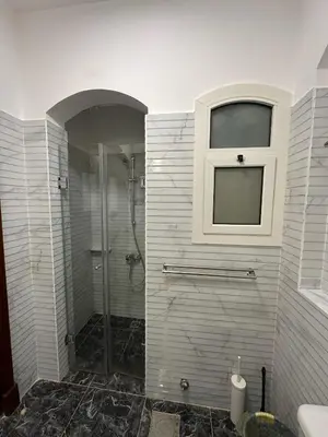a bathroom with a shower and a window at 2 Bedroom Ground Floor New Nubia - 2 minutes walk to marina Abu Tig in Hurghada