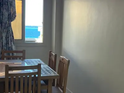 a dining room with a table and chairs and a window at Dream apartment1 in Hurghada