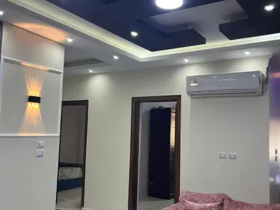 a room with a ceiling with a fan and a mirror at Dream apartment1 in Hurghada