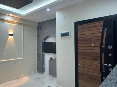 a hallway with a wooden door and a light at Dream apartment1 in Hurghada