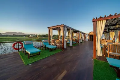 a deck with chairs and tables and a pavilion at Princess Farida Luxury Dahabiya Nile Cruise, Every Monday from Luxor to Aswan 4 nights and Every Friday from Aswan to Luxor 3 nights in Luxor