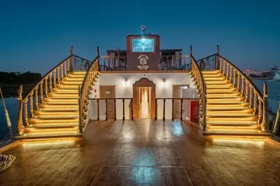 a set of stairs leading to a building with a clock at Princess Farida Luxury Dahabiya Nile Cruise, Every Monday from Luxor to Aswan 4 nights and Every Friday from Aswan to Luxor 3 nights in Luxor