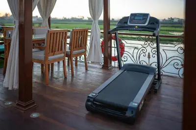 a suitcase sitting on the floor in a room with a table at Princess Farida Luxury Dahabiya Nile Cruise, Every Monday from Luxor to Aswan 4 nights and Every Friday from Aswan to Luxor 3 nights in Luxor