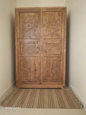 a wooden door in the corner of a room at Kemet House in Luxor