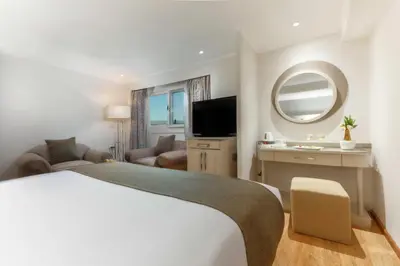 a hotel room with a large bed and a mirror at Orient Sun Times Nile Cruise-Every Monday from Luxor for 04 & 07 Nights - Every Friday From Aswan for 03 Nights in Luxor