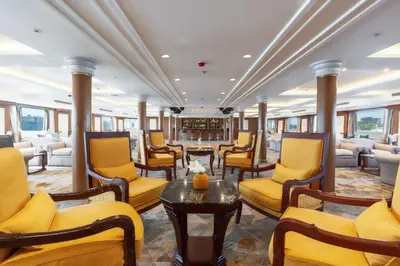 a waiting room with yellow chairs and a table at Orient Sun Times Nile Cruise-Every Monday from Luxor for 04 & 07 Nights - Every Friday From Aswan for 03 Nights in Luxor