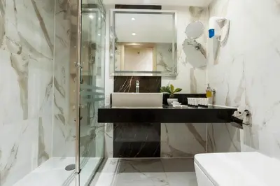 a bathroom with a sink and a shower at Orient Sun Times Nile Cruise-Every Monday from Luxor for 04 & 07 Nights - Every Friday From Aswan for 03 Nights in Luxor
