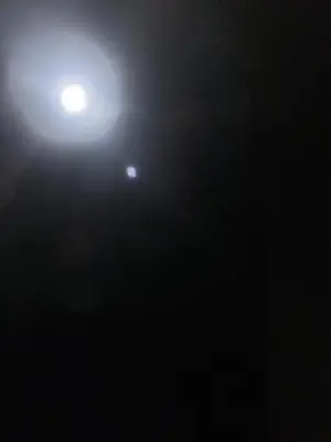 a street light in the dark with the moon in the background at Bbbbbbbbbbb in Hurghada