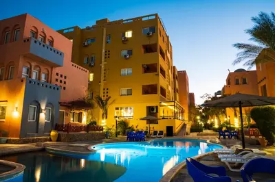 a hotel with a swimming pool in front of a building at Al Dora Residence Apartments in Hurghada