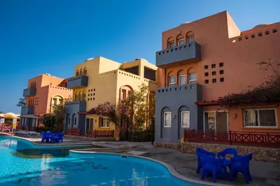 a resort with a swimming pool in front of a building at Al Dora Residence Apartments in Hurghada