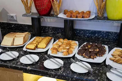 a buffet with many different types of bread and pastries at Al Dora Residence Apartments in Hurghada