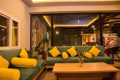 a living room with a green couch with yellow pillows at Al Dora Residence Apartments in Hurghada