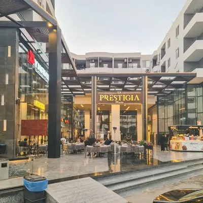 a restaurant with tables and chairs in a building at La Prestigia in Hurghada